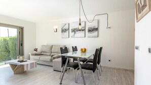 A modern dining area with a glass table, black chairs, and a hanging light fixture. - VISTA MONTE ( Francisca ). Apartment in residentail area near The beach. (Puerto Pollensa)