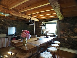 A rustic kitchen with a wooden island, stone walls, and a stone fireplace. - SHEEPFOLD PANORAMIC VIEW ON THE VALLEY OF ARGELES AND MOUNTAINS (ARTALENS -SOUIN)