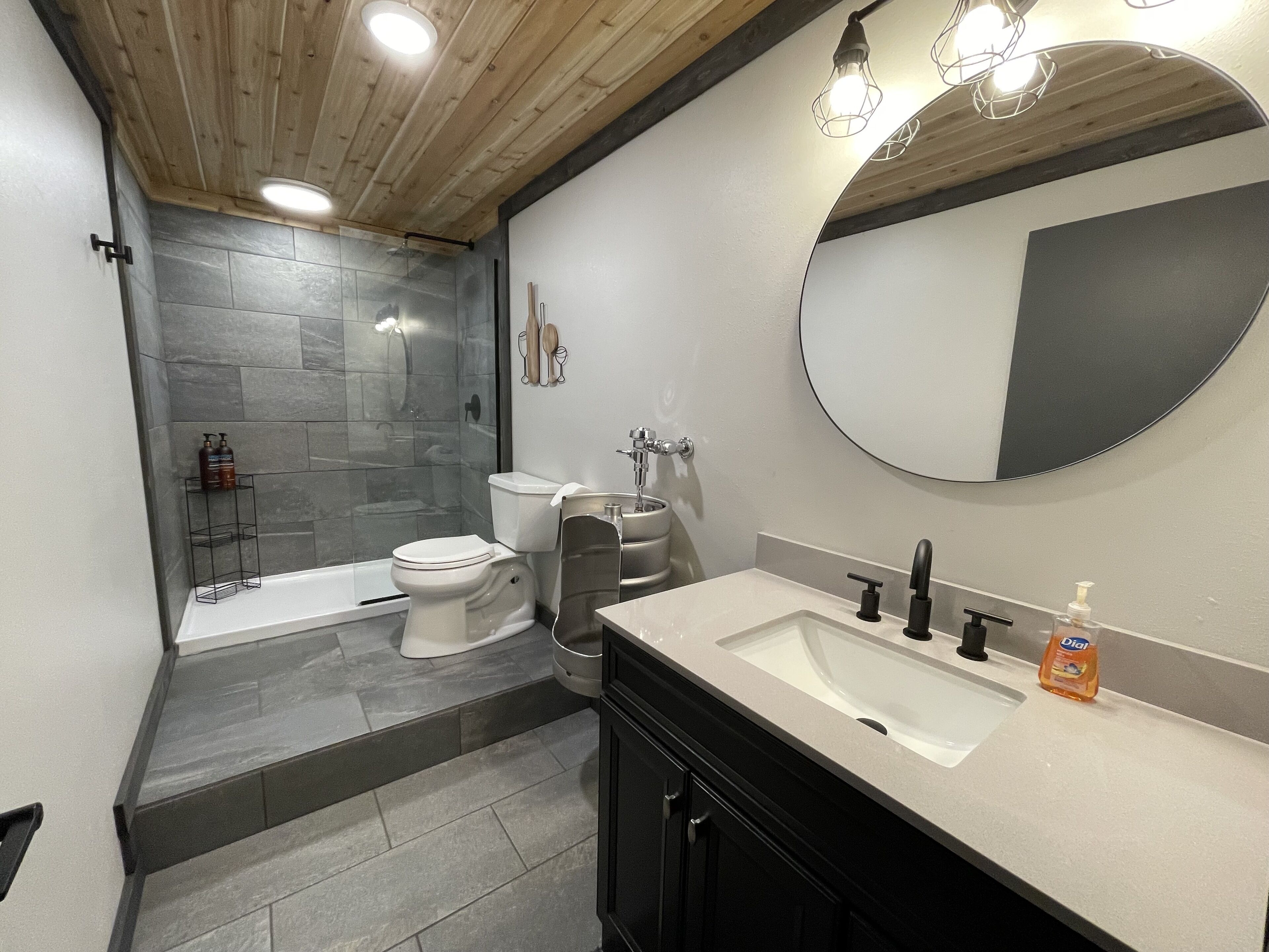 A modern bathroom with a bathtub, toilet, and sink.