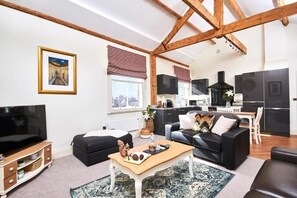 A modern apartment with a living room, kitchen, and dining area. - 💎✨ Step Inside the Magical Gem of York 💎✨ (York)