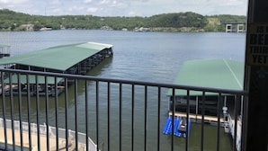 A view of a lake with docks and a covered area.