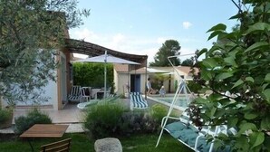 A patio with outdoor seating, a pool, and a stone feature. - VILLA CLOSE TO UZES COMFORT 3 EPIS *** WITH PRIVATE POOL HEATED AT SALT (Arpaillargues-Et-Aureillac)