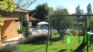 A backyard with a swing set, a small pool, and a patio area. - VILLA CLOSE TO UZES COMFORT 3 EPIS *** WITH PRIVATE POOL HEATED AT SALT (Arpaillargues-Et-Aureillac)