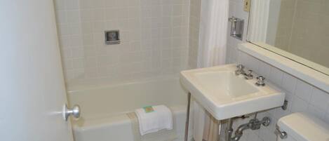 A bathroom with a bathtub, a sink, and a toilet.