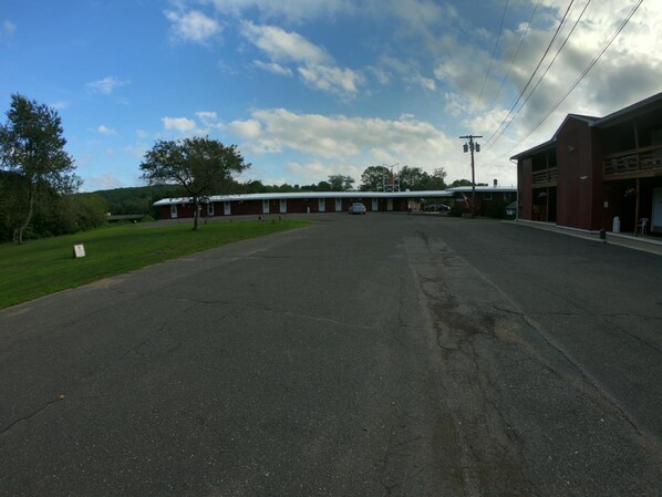 A large, single-story building with a flat roof and a parking lot in front.