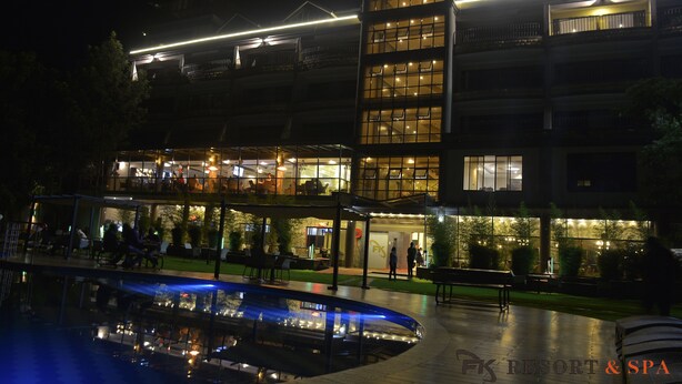 A multi-story hotel with outdoor seating and a pool. - FK Resort & Spa (Marua)