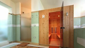 A sauna room with wooden walls and a tiled floor.
