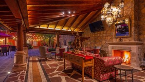 A cozy interior with a stone fireplace, wooden furniture, and a ceiling with exposed beams. - Hotel Boutique & Spa Casa Colorada (Patzcuaro)