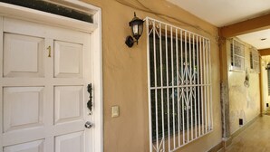 A white door with a number '1' and a metal gate with decorative bars. - Villas Velarde + Pool + Great Location (cozumel)
