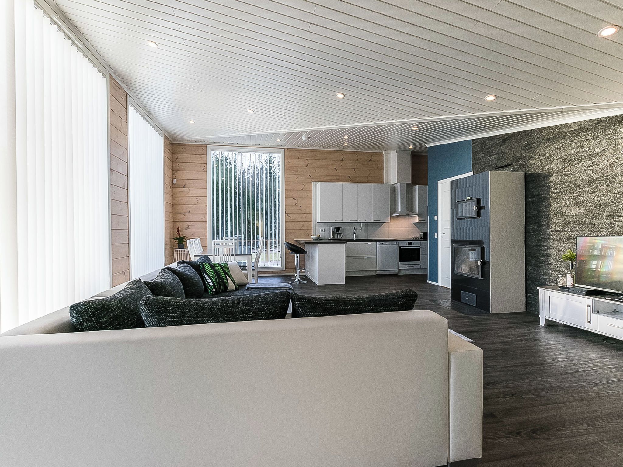A modern interior with a living area, kitchen, and dining space.