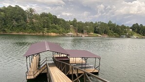A wooden dock extending into a lake with a covered seating area and a small pavilion. - Discover Your Convenient Paradise: Minutes from I-65, Cullman, and Boat Launch (Cullman)