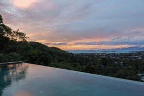 Een buitenzwembad en een infinitypool