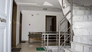 A hotel lobby with a marble staircase, a reception desk, and a view of the interior. - Pyrgos Sofokleous (Lesvos)