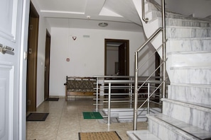 A hotel lobby with a marble staircase, a reception desk, and a view of the interior. - Pyrgos Sofokleous (Lesvos)