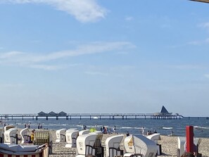 Guests can enjoy beachside accommodations in one of our numbered huts, with a pier stretching out to sea.