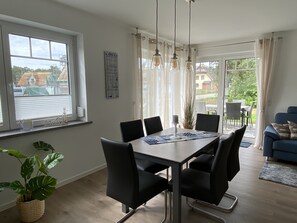 Enjoy meals with friends and family at this dining area, featuring a table for six and comfortable seating.