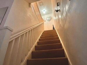 A staircase with wooden steps and white railings leading to a landing. - Mathew Street Penthouse 2 bed sleeps 4 (Liverpool)