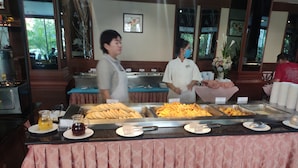 A buffet area with various food items and a counter. - Hotel Stern Pattaya (Pattaya)