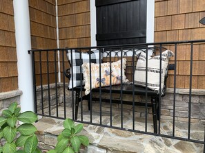 Step out onto the porch, surrounded by autumnal charm, and enjoy the warm atmosphere.