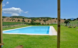 Relax by the serene pool surrounded by lush greenery and picturesque views.