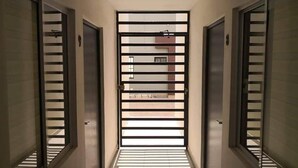 A hallway with a central door leading to a balcony.