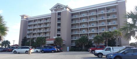 A multi-story hotel with a central courtyard and several balconies.