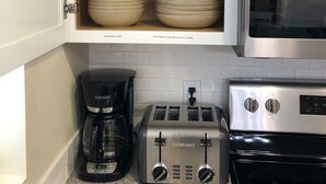 A kitchen with a microwave, toaster, and coffee maker. - Beautiful-condo-townhouse- Sleeps 8 - 8 Minute walk to Beach - Near Pier Park (Panama City Beach)