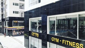 A modern building with a 'Full House' and 'Captain Fitness' sign, featuring large glass windows and a staircase leading to the entrance. - Jolie Home - Sky Center - Block A (Ho Chi Minh City)
