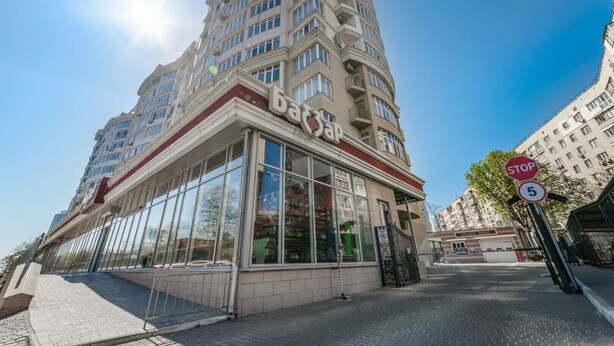 A modern building with a glass facade and a 'bap' sign, indicating a business or commercial use. - Sunset lovers in Odessa (Odessa)