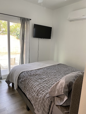 Bedroom with internet tv and double doors for patio entrance.