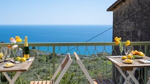 A balcony with a table set for dining, overlooking a coastal view. - Beautiful  villa for 6 guests with WIFI, TV, terrace, pets allowed and panoramic view (Cipressa)