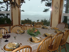Enjoy meals in this beautifully set dining area with a tablecloth, comfortable chairs, and a stunning view.