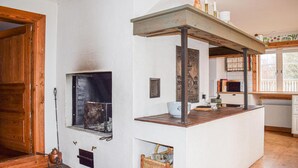 A kitchen with a built-in stove, wooden cabinets, and a window overlooking a deck. - Beautiful home in Lammhult with sauna (Lammhult)