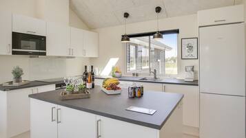 Fridge, stovetop, dishwasher, coffee/tea maker