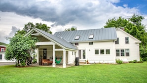 A white two-story house with a covered porch and a green hammock. - Waterfront, Swimming Hotspot, Private Down Town Location, Farmhouse (Waitsfield)