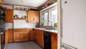 Enjoy cooking in this well-lit kitchen with a dishwasher and ample storage.