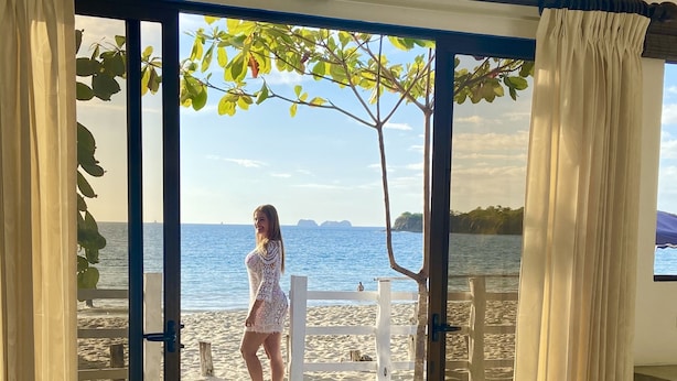 A room with a large sliding glass door leading to a balcony with a view of the sea. - Amazing right on the water, BEACHFRONT studio near Tamarindo (POTRERO)