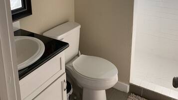 Shower, hair dryer, towels, toilet paper