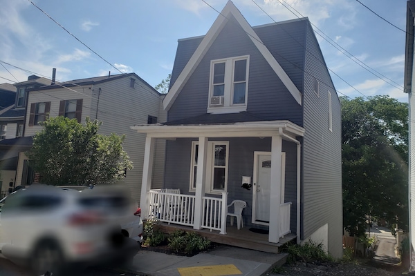 Front of the house, porch and entry. Parking on the street and in the back.