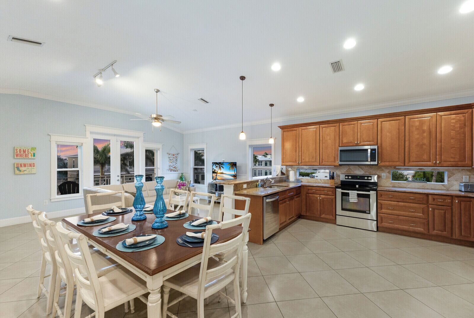 A spacious kitchen with wooden cabinets, a microwave, and a large island.