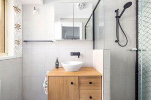 Bathtub, hair dryer, soap, toilet paper
