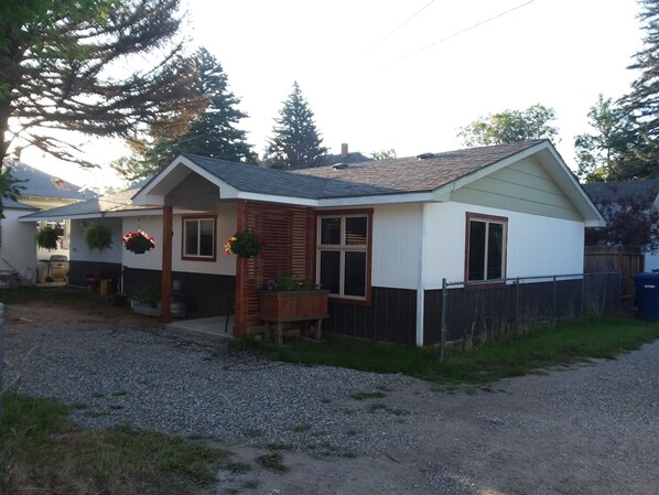 A single-story house with a sloped roof, a front porch, and a fenced yard. - Conveniently Located close to downtown. No stairs to climb. (Livingston)