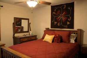 A bedroom with a bed, a nightstand, a dresser, a mirror, and a ceiling fan. - Conveniently Located close to downtown.  No stairs to climb. (Livingston)