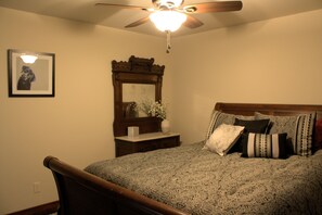 A bedroom with a bed, a nightstand, a mirror, and a ceiling fan. - Conveniently Located close to downtown. No stairs to climb. (Livingston)