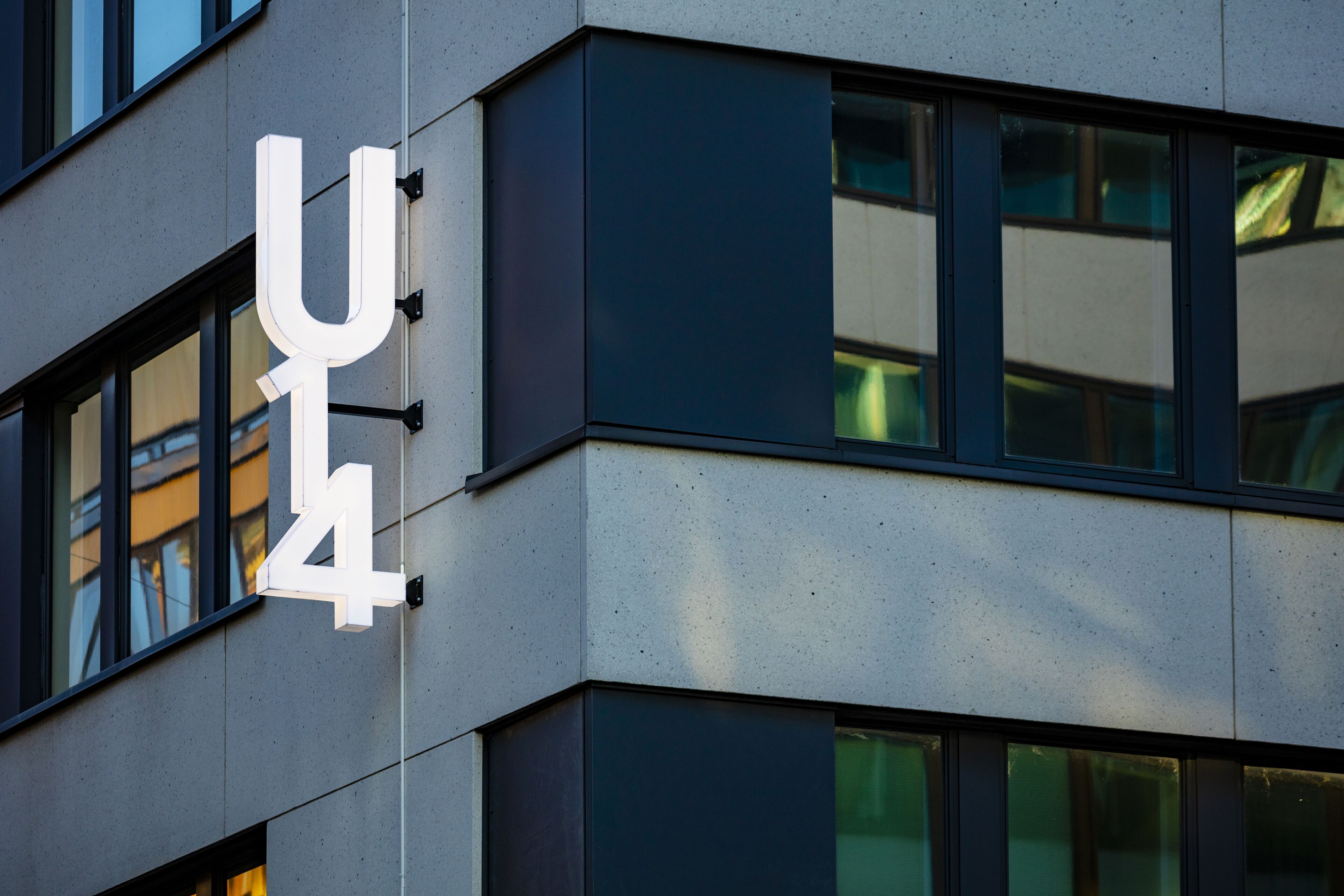 A building with a large, white, illuminated sign displaying the number '4'.
