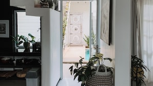 A modern kitchen with a large window, a built-in oven, and various kitchen appliances. - Casa Artista By Villa Kresna (Seminyak)