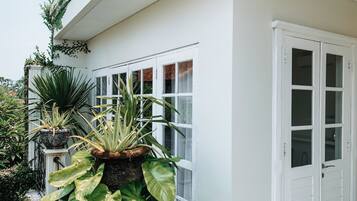 A white exterior wall with a door and windows.