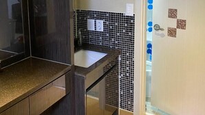 A modern bathroom with a dark wood vanity, a tiled backsplash, and a door with a blue polka dot curtain. - Home sweet home!!!!! (Pyeongtaek-si)