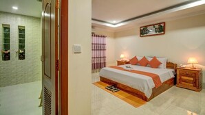 A bedroom with a bed, two bedside tables, a nightstand, a window with curtains, a wall-mounted painting, and a door. - Deluxe Double Room - breakfast (Kok chock commune)