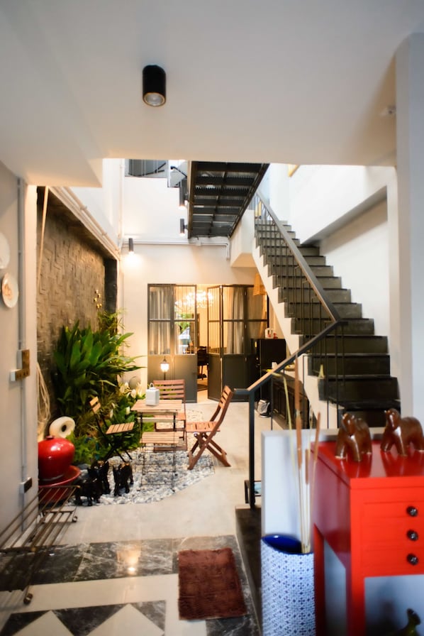 A modern interior with a staircase, a dining area, and a kitchen.